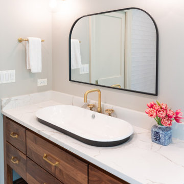 Guest Bathroom Vanity with Modern Brass Fixtures and Crisp Countertops