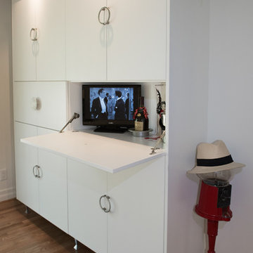 Pantry (6'w X 7'h X 1'd) with tip-down doors stores small TV, micro & bar