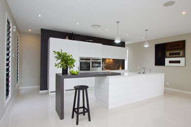 Inspiration for a contemporary kitchen in Brisbane with quartz benchtops, matchstick tile splashback and ceramic floors.