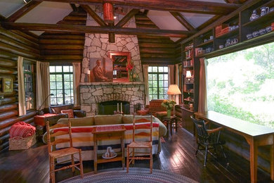 Living room - mid-sized rustic loft-style dark wood floor living room idea in Chicago with brown walls, a standard fireplace, a stone fireplace and no tv