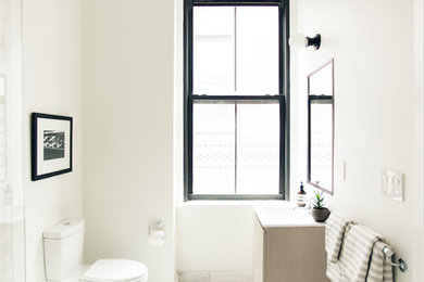 Example of a minimalist gray tile and marble tile marble floor and gray floor bathroom design in Providence with flat-panel cabinets, light wood cabinets, white walls and quartz countertops