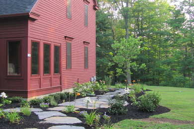 This is an example of a large traditional side yard stone formal garden in Boston.