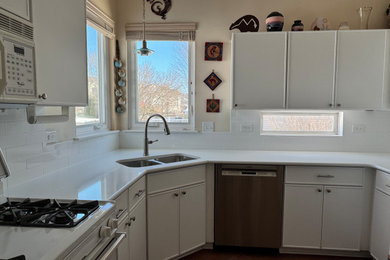 Inspiration for a mid-sized transitional kitchen remodel in Chicago with shaker cabinets, white cabinets, quartz countertops, white backsplash, subway tile backsplash and white countertops