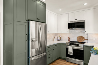 Photo of a small traditional u-shaped kitchen/diner in Los Angeles with a double-bowl sink, shaker cabinets, green cabinets, engineered stone countertops, white splashback, stainless steel appliances, no island and white worktops.
