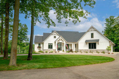 Example of a farmhouse exterior home design in Grand Rapids