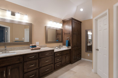 Photo of a mid-sized transitional master bathroom in Dallas with shaker cabinets, medium wood cabinets, a two-piece toilet, brown tile, porcelain tile, beige walls, porcelain floors, an undermount sink, granite benchtops, beige floor and beige benchtops.
