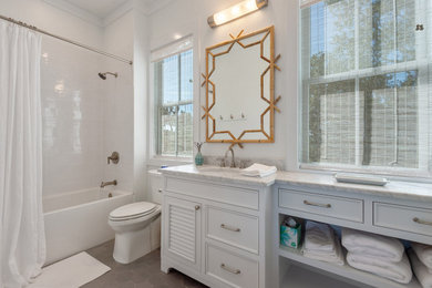 Bathroom - mid-sized traditional master white tile and ceramic tile ceramic tile, gray floor and single-sink bathroom idea in New Orleans with flat-panel cabinets, white cabinets, a two-piece toilet, white walls, an undermount sink, marble countertops, white countertops and a built-in vanity