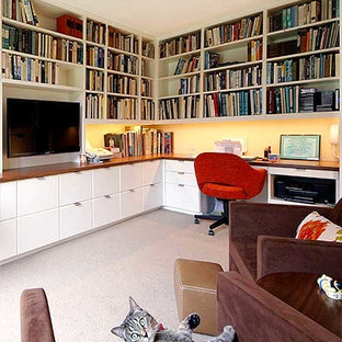 Design ideas for a medium sized modern home office and library in New York with a reading nook, white walls, carpet, no fireplace, a built-in desk and grey floors.