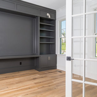 Inspiration for a medium sized modern home office and library in Charlotte with a reading nook, grey walls, light hardwood flooring, a built-in desk and multi-coloured floors.
