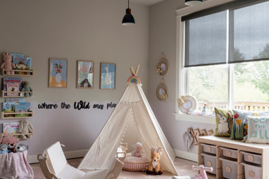 Example of a mid-sized eclectic gender-neutral medium tone wood floor and wallpaper kids' room design in Seattle with gray walls