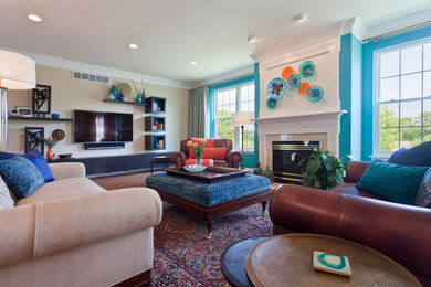 This is an example of a large transitional open concept family room in Philadelphia with blue walls, a standard fireplace, a plaster fireplace surround, a wall-mounted tv, medium hardwood floors and brown floor.