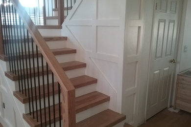 Idées déco pour un grand escalier contemporain en U avec des marches en bois, des contremarches en bois, un garde-corps en matériaux mixtes et du lambris.