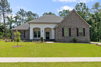 Example of a mid-sized classic white one-story brick exterior home design in Other with a shingle roof and a gray roof