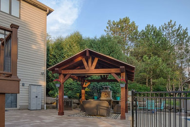 Example of a mid-sized trendy backyard patio design in Other