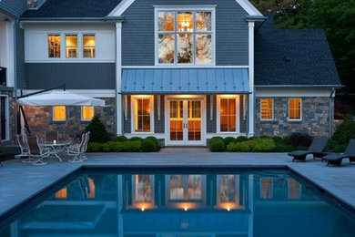 Pool house - huge transitional courtyard stone and rectangular lap pool house idea in Boston