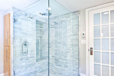 Corner shower - transitional master porcelain tile corner shower idea in Calgary with gray walls