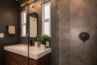 Inspiration for a mid-sized modern master black tile black floor and single-sink walk-in shower remodel in Los Angeles with brown cabinets, black walls, a drop-in sink, quartzite countertops, a hinged shower door, white countertops and a floating vanity
