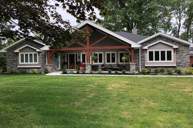 Huge cottage gray one-story mixed siding and clapboard exterior home photo in Cincinnati with a shingle roof and a black roof