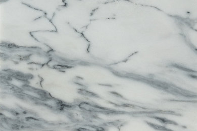 Honed Pele Tigre marble surface, white ground with dense slate-blue veining