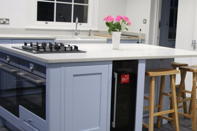 Inspiration for a large country eat-in kitchen in Berkshire with shaker cabinets, blue cabinets, slate floors and a peninsula.