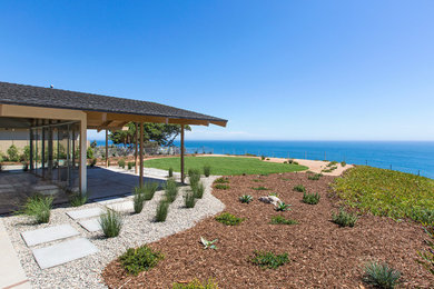 Inspiration for a large transitional beige one-story wood gable roof remodel in Los Angeles