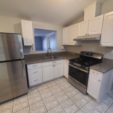 Rent-Ready Kitchen with White Cabinets and Dark Granite