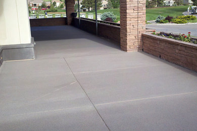 Mid-sized elegant front yard concrete patio photo in Denver with a roof extension