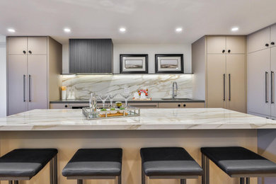 Inspiration for a large contemporary l-shaped open plan kitchen in Toronto with an undermount sink, flat-panel cabinets, beige cabinets, quartz benchtops, beige splashback, stone slab splashback, panelled appliances, light hardwood floors, with island, beige floor and beige benchtop.