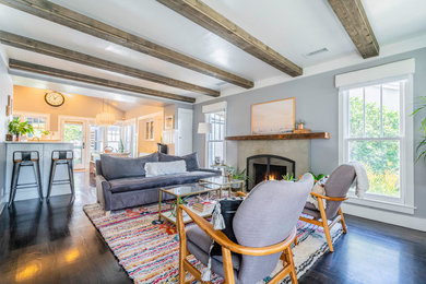 Inspiration for a mid-sized eclectic formal and open concept dark wood floor and brown floor living room remodel in Los Angeles with gray walls, a standard fireplace, a concrete fireplace and a tv stand