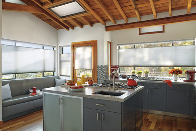 Inspiration for a mid-sized contemporary l-shaped dark wood floor eat-in kitchen remodel in San Francisco with an undermount sink, flat-panel cabinets, gray cabinets, multicolored backsplash, mosaic tile backsplash, stainless steel appliances and an island