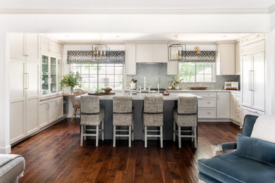 Kitchen - mid-sized transitional dark wood floor kitchen idea in Los Angeles with a single-bowl sink, recessed-panel cabinets, beige cabinets, quartzite countertops, gray backsplash, stainless steel appliances, an island and gray countertops
