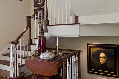 Example of a large classic medium tone wood floor entryway design in Cleveland with white walls and a medium wood front door