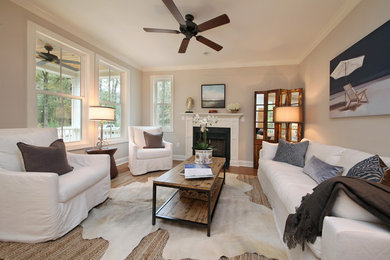 Inspiration for a small transitional living room remodel in Charleston with gray walls, a standard fireplace and a stone fireplace