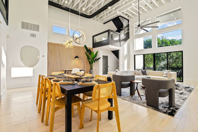 Living room - huge contemporary open concept light wood floor, brown floor and exposed beam living room idea in Dallas with a standard fireplace, a tile fireplace and a media wall