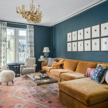 Bold Blue Living Room with Gallery Wall and Brass Statement Chandelier