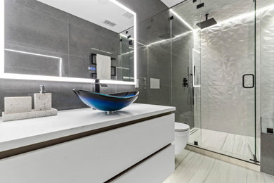 Small minimalist gray tile and ceramic tile ceramic tile, white floor and single-sink bathroom photo in Dallas with flat-panel cabinets, white cabinets, a wall-mount toilet, a pedestal sink, quartzite countertops, a hinged shower door, white countertops and a floating vanity