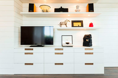 Example of a trendy open concept dark wood floor living room library design in Austin with white walls