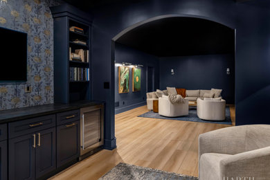 Inspiration for a large transitional look-out light wood floor, brown floor and wallpaper basement remodel in Philadelphia with a home theater and blue walls
