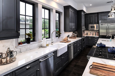 Design ideas for a large transitional l-shaped eat-in kitchen in Miami with a farmhouse sink, recessed-panel cabinets, black cabinets, marble benchtops, multi-coloured splashback, stone slab splashback, stainless steel appliances, dark hardwood floors and with island.