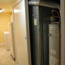 Mechanical Closet With 2 4' Wide Solid Core Bypass Doors - Storage And Organization