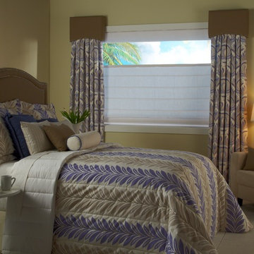 Layered drapes and shades match patterned bedding