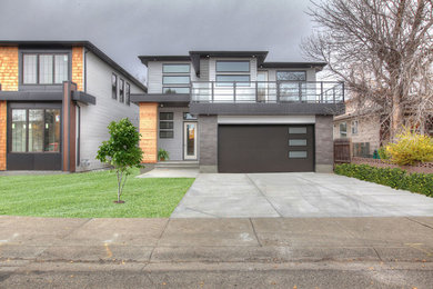 Large minimalist gray two-story exterior home photo in Calgary