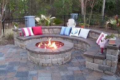 Photo of a backyard patio in Raleigh with a fire feature and natural stone pavers.