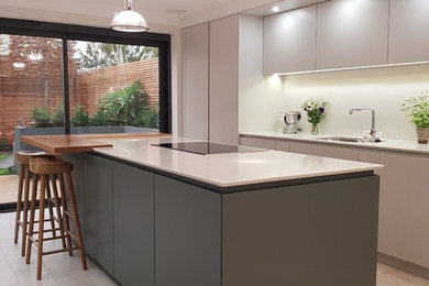 Photo of a large contemporary single-wall open plan kitchen in Other with flat-panel cabinets, grey cabinets, quartz worktops, white splashback, marble splashback, stainless steel appliances, porcelain flooring, an island and grey floors.