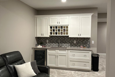 Example of a large trendy underground carpeted and gray floor basement design in Cleveland with a home theater and gray walls
