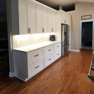 White Kitchen with Quartz Countertop, Galley Workstation and Large Subway Tile