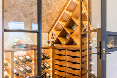 Wine cellar - mid-sized contemporary medium tone wood floor wine cellar idea in Austin