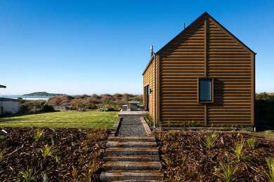 Inspiration for a small beach style one-storey exterior in Dunedin with wood siding.
