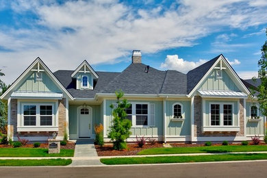 Example of a mid-sized beach style green one-story wood gable roof design in Boise