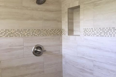 Contemporary bathroom in Los Angeles with an alcove shower, travertine and beige walls.